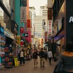 Busy Seoul street lined with shop signs, where learning how to use Naver Map in English helps you find your way